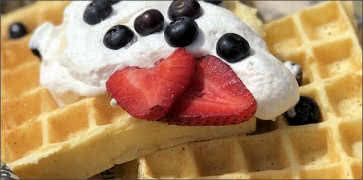 Waffles with Whipped Cream and Mixed Fresh Berries