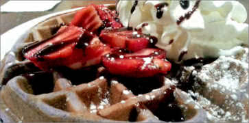 Waffles with Strawberries, Whipped Cream and Chocolate Sauce